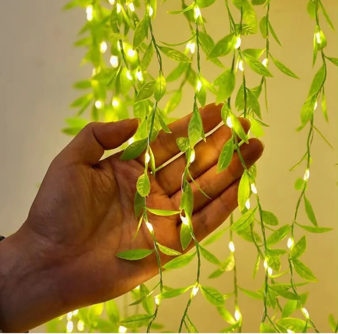 Leaf LED string light close-up held in hand showing green leaves and warm-white LEDs – Craft Decor